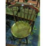 A set of four Swedish stained beechwood stick back kitchen chairs with circular seats raised on