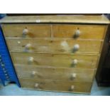 A Victorian stripped pine bedroom chest of four long and two short graduated drawers with turned