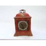 A Georgian style crimson lacquered mantle clock with chinoiserie detail enclosing an eight day