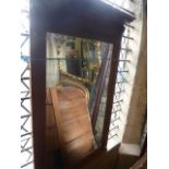 A wall mirror with rectangular bevelled edge plate within an oak moulded frame with lions mask and