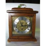 An oak cased Woodford three train musical shelf/bracket clock, fitted with a 5.5inch brass dial, the