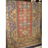 An Afghan wool runner decorated with pink and blue medallions upon an ivory ground