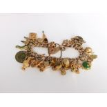 A 9ct gold charm bracelet with some 9ct charms and other unmarked yellow metal charms, 67g approx