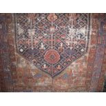 A Persian type floor rug centrally decorated with a large blue geometric floral medallion upon a