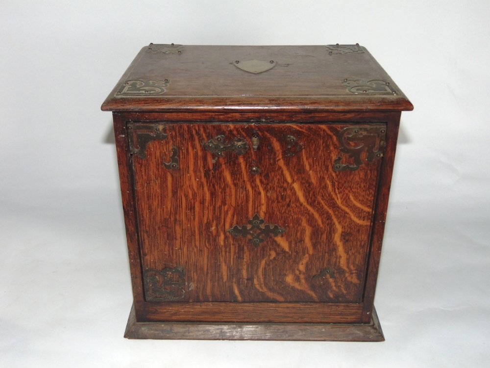 Interesting late 19th century oak smokers box, with levered fall front enclosing a fitted