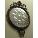 A mid-19th century wall mirror, the circular gilded frame with scrolled and other detail, the mirror