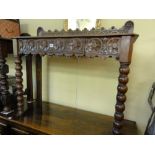 A Victorian oak hall table of rectangular form with geometric carved detail raised on bobbin