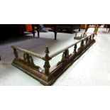 A Regency brass fire kerb with baluster supports