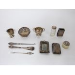 A collection of Victorian and later sterling silver items to include two small trophy cups, a