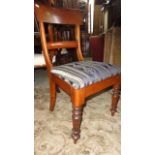 A set of four mahogany spade back dining chairs with drop in seats on turned supports together