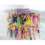 A collection of vintage and more recent Barbie and Action Man dolls to include accessories