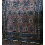 A Kashan floor rug decorated with blue and ivory floral medallions upon a pink ground, 285cm x