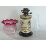 Lambeth style stoneware oil lamp, the body decorated with blue and white floral sprays, with