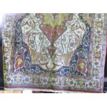 A large Persian type floor rug decorated with scrolled foliage and medallion borders upon a cream