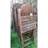 Eight teak wood garden chairs with slatted seats and backs and folding frames