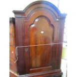 A Georgian mahogany freestanding corner cupboard, the lower section enclosed by a panelled door, the