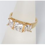 A 14ct gold three stone ring set with three large square cut cubic zirconia 3.1g, ring size O