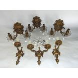 A box containing various gilt cast metal twin and single branch wall sconces