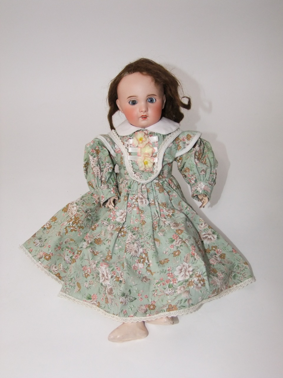 An antique S. F. B. J. porcelain headed doll, 18 inches long, with shutting eyes, open mouth and