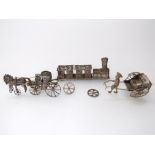 A collection of novelty Indian/Asian white metal items to include a filigree train, and horse