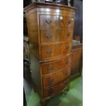 A reproduction Georgian style bow fronted chest on chest of six long drawers, 56 cm wide, together