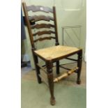 A set of six old English style ladderback dining chairs with rush seats on pad feet