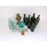 A collection of antique and vintage glass bottles including examples with moulded descriptions