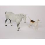 A Beswick model of a standing horse with grey dappled patches together with a Beswick model of a