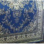 A large Kashan carpet decorated with various gold medallions upon a blue ground, 285cm x 320cm