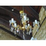 Gilt metal five branch chandelier with glass drip trays and prismatic drops