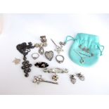 A small collection of silver and unmarked white metal costume jewellery items to include a Tiffany