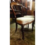 A pair of Victorian mahogany balloon back dining chairs on turned supports