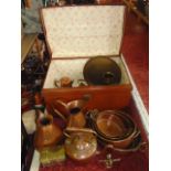 A good tin trunk filled with various copper and brass ware to include graduated jugs, jam pans, a