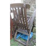 A single teak wood steamer chair with extending foot