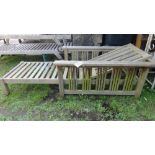 A pair of Barlow Tyrie teak wood loungers in an arts and crafts style