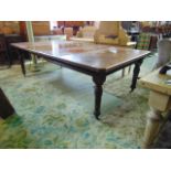 A late 19th century oak extending dining table with two additional leaves on turned supports,