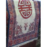 A Chinese silk floral rug decorated with a central Chinese medallion and still lives of flowers in