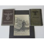 A collection of Austrian WWII ephemera including a black and white photograph of a pilot with his