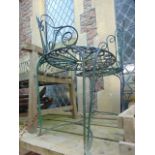 A Victorian style iron love or conversation seat with scrolled detail