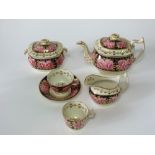 A collection of early 19th century tea wares in the Coalport manner with pink open rose decoration