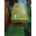 A reclaimed striped and waxed pine coffee table of rectangular form with panelled top and planked