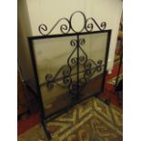 A wrought iron and mesh fire screen together with a wrought iron companion set