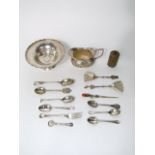 A collection of silver items to include a small tazza on stepped foot, a milk jug with half fluted