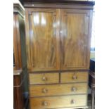 A Victorian mahogany linen press, the lower section enclosed by two long and two short drawers,