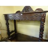 A Victorian oak hall table of rectangular form with geometric carved detail raised on bobbin