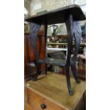An early 20th century carved floral occasional table, the cabriole legs supporting an under tier,