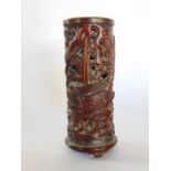 A Japanese carved hardwood brush pot decorated with a shipping scene with figures, 11 cm high