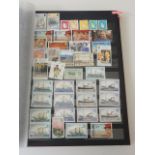 A collection of world stamps, mostly Commonwealth, mint and used in a large 64 black page album