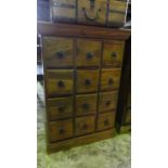 A pair of Indian hardwood cabinets each enclosing twelve drawers with iron ring handles