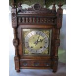 A German walnut ting tang two train shelf clock within an architectural case with turned columns and